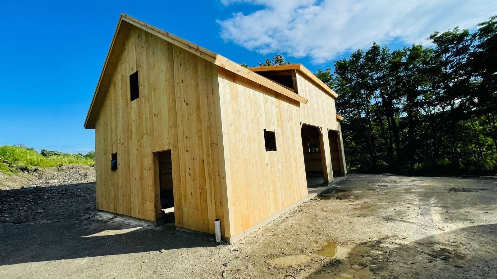 The same DA Home Improvement barn finished and clad with wood siding.