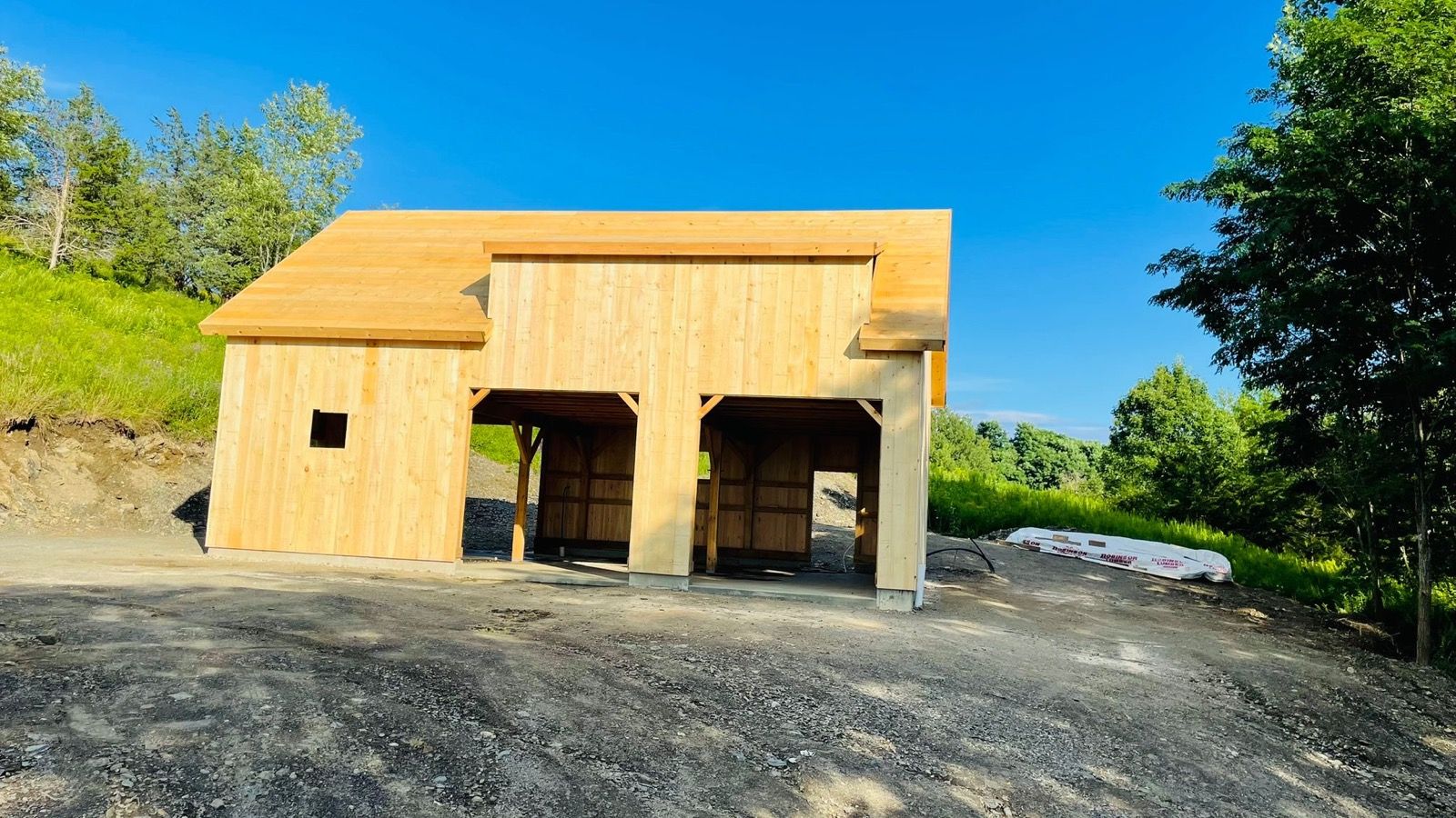 Finished timber-frame garage with wood siding.