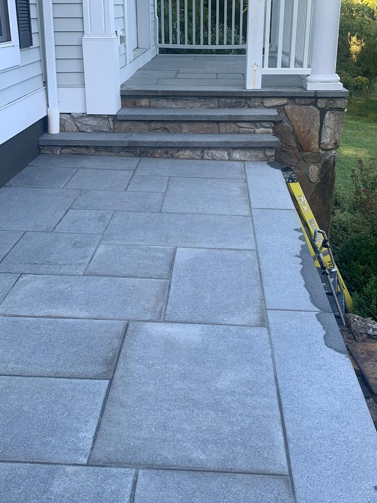 Bluestone walkway leading to a home entrance.