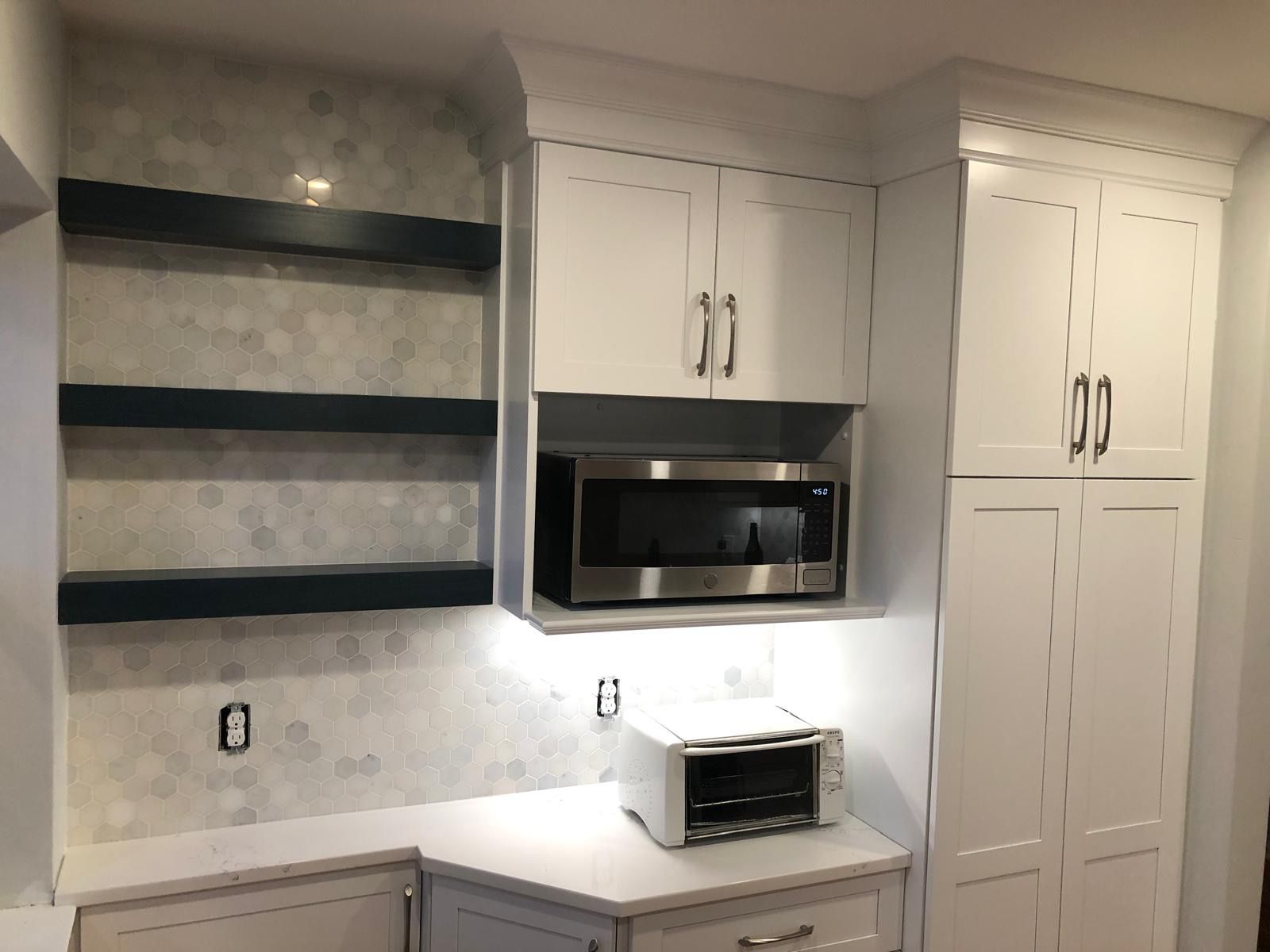 Custom white cabinetry in a finished kitchen.
