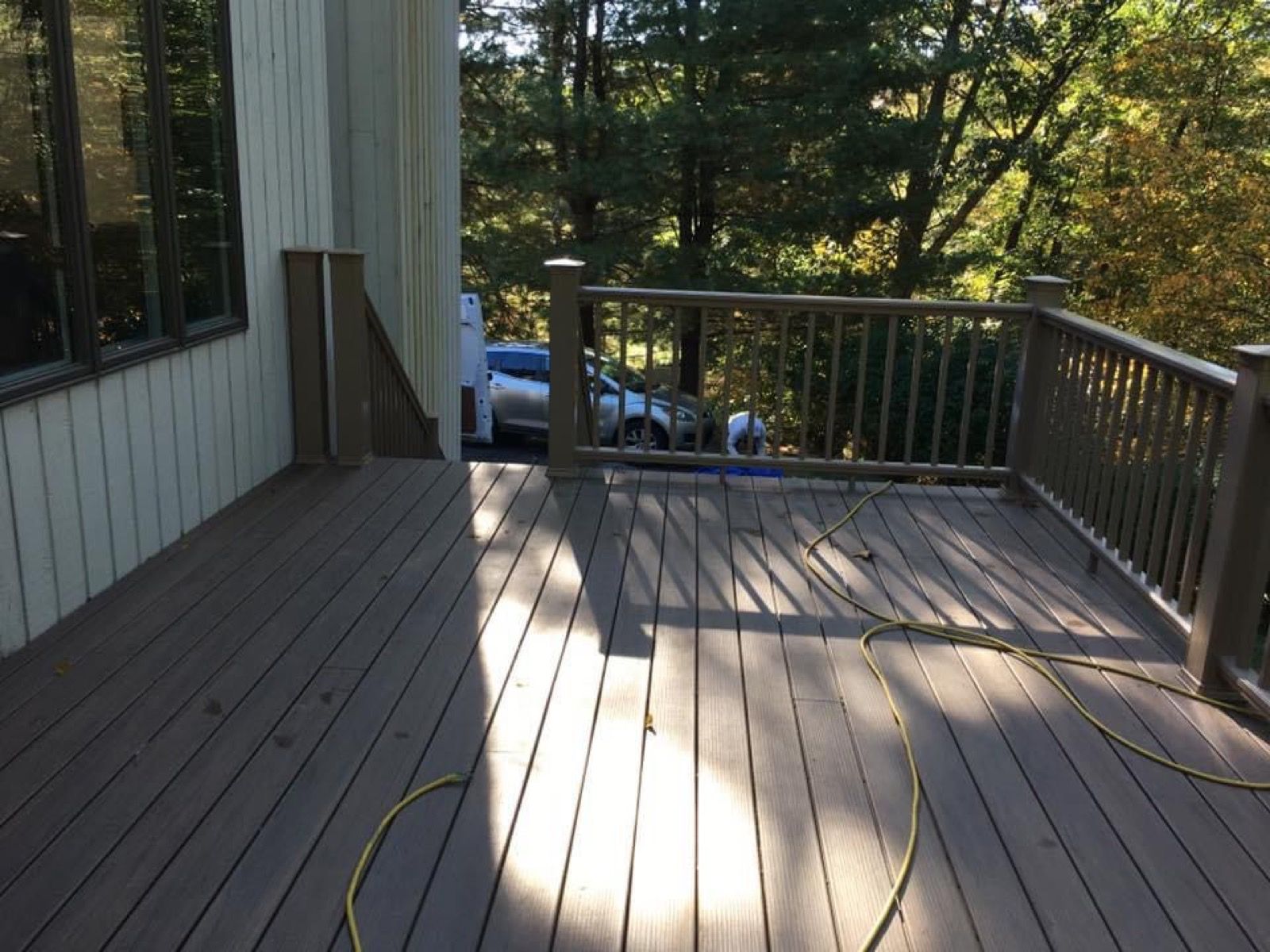 Composite deck with railing overlooking the woods.