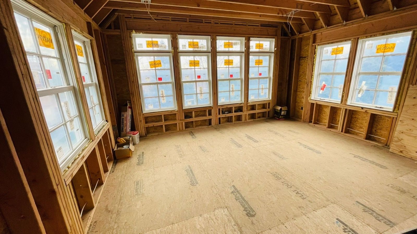 Interior framing ready for drywall, windows roughed in.