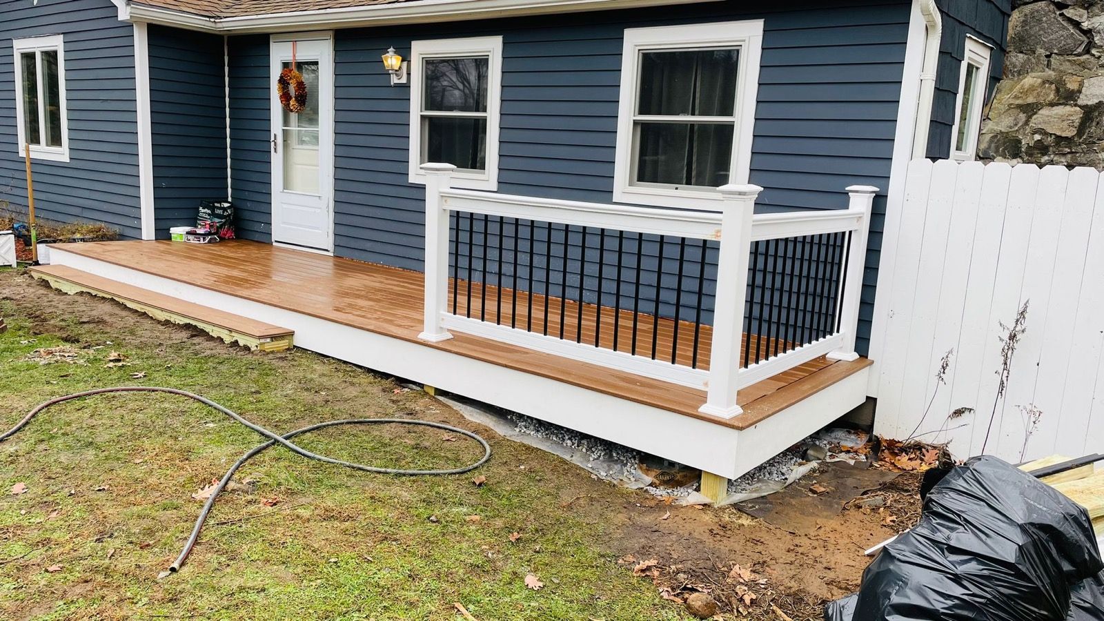Navy-sided home with a fresh white front porch.