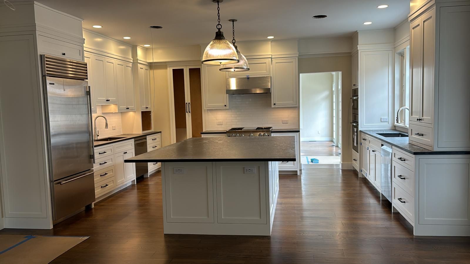 Remodeled kitchen with a large island and stainless appliances.