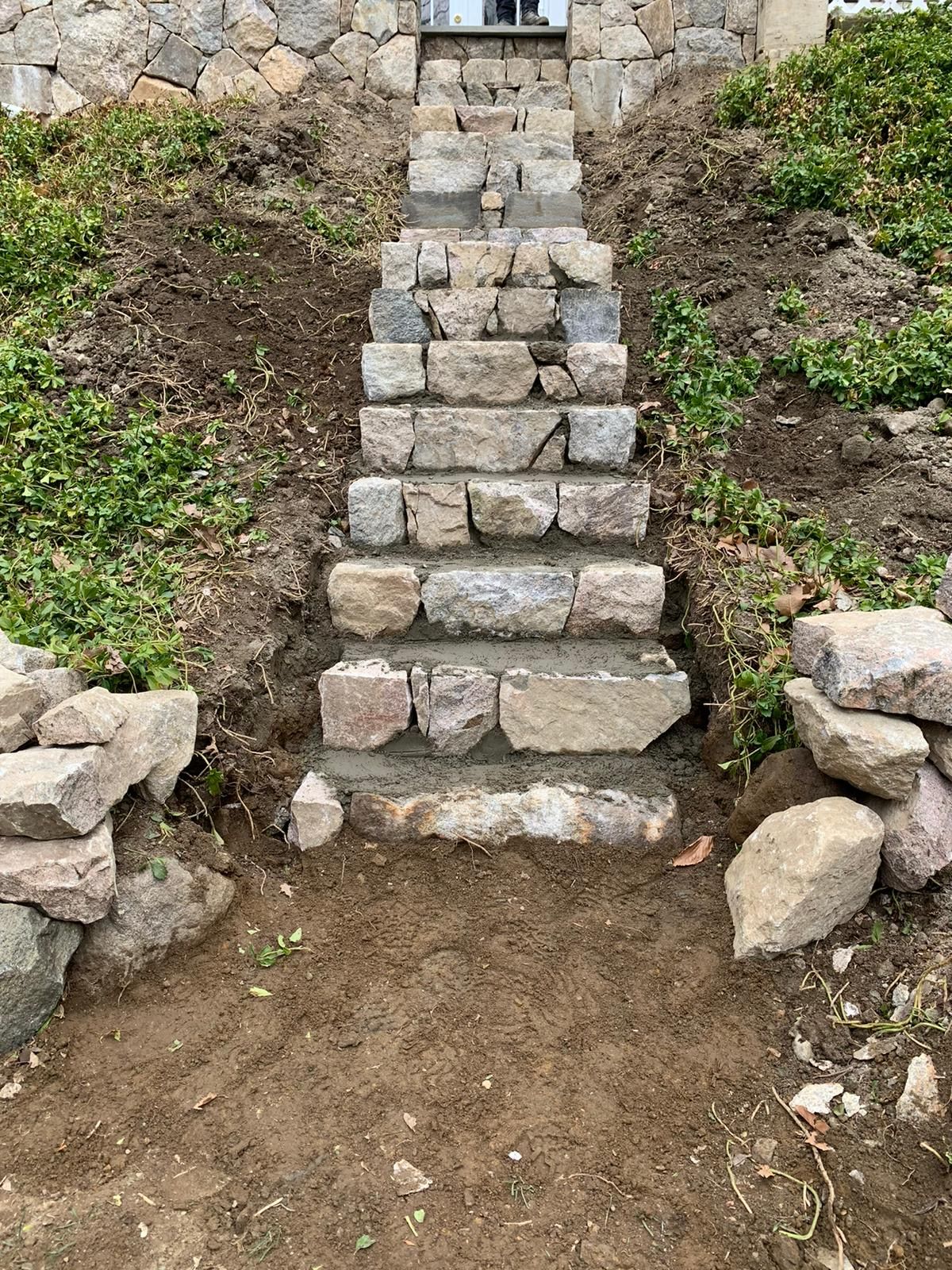 Fieldstone garden steps built into a planted slope.